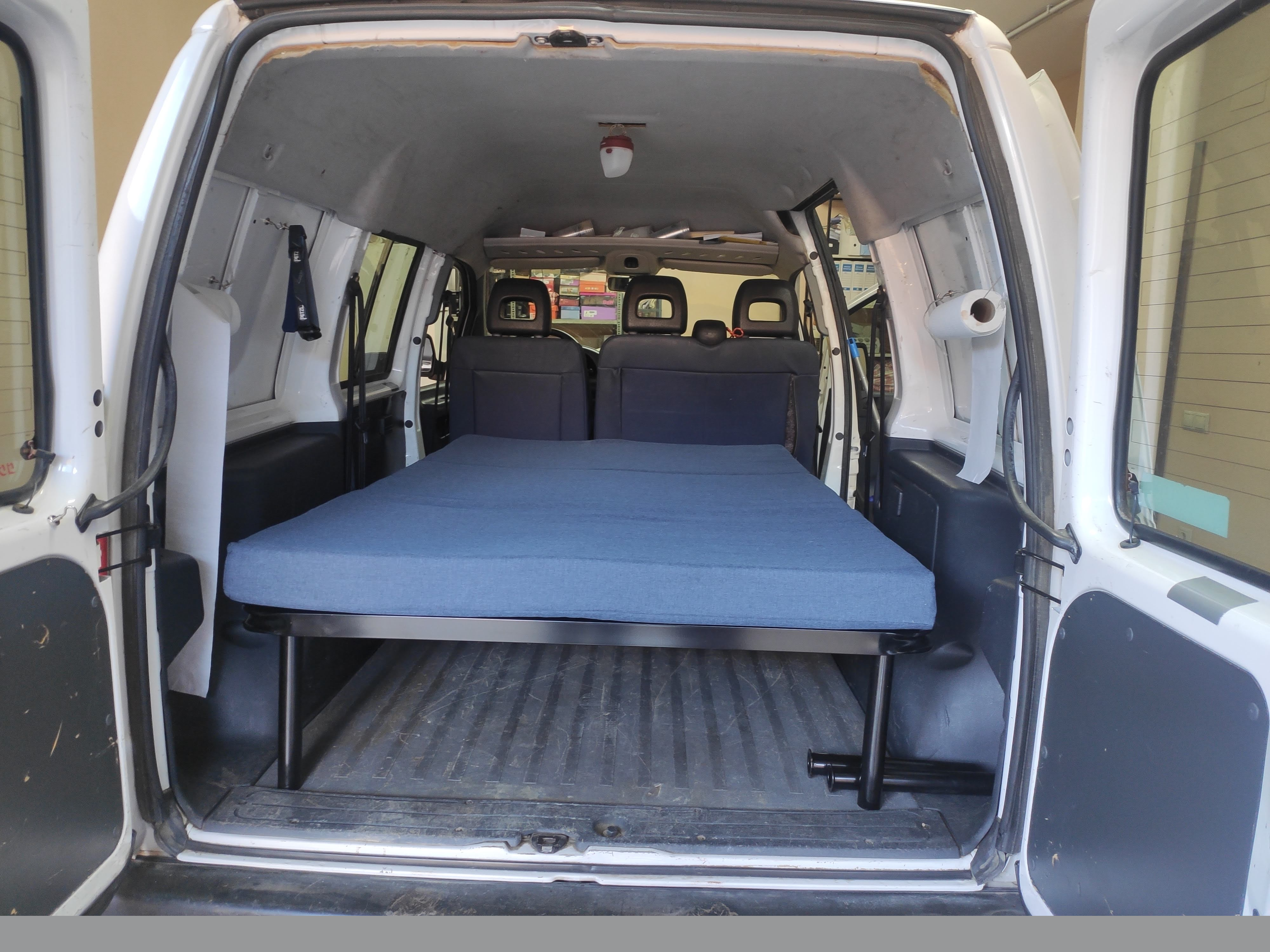 Bed with new bed frame mounted in the van