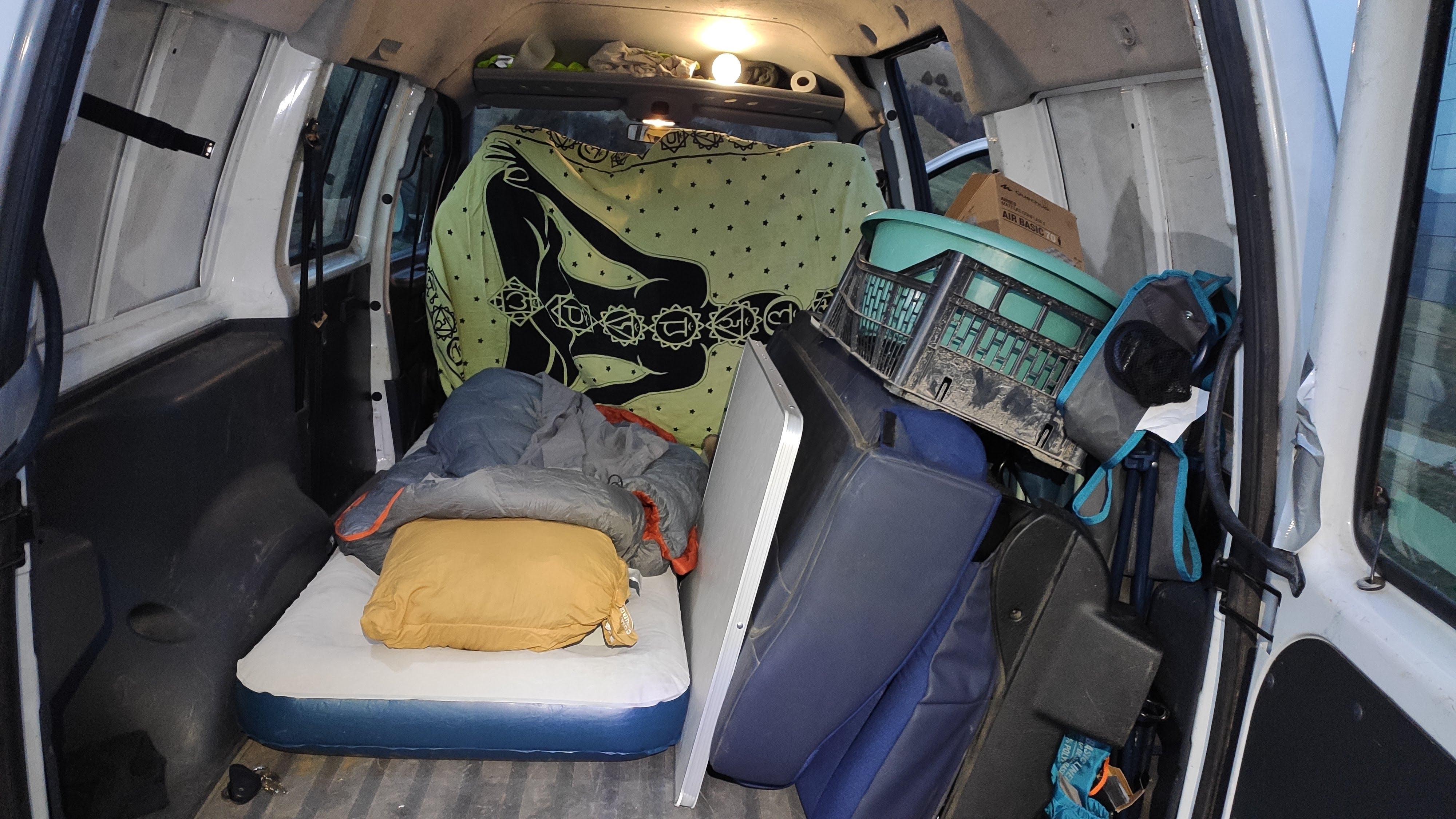 Air mattress in the back of the van with the original seats still in place
