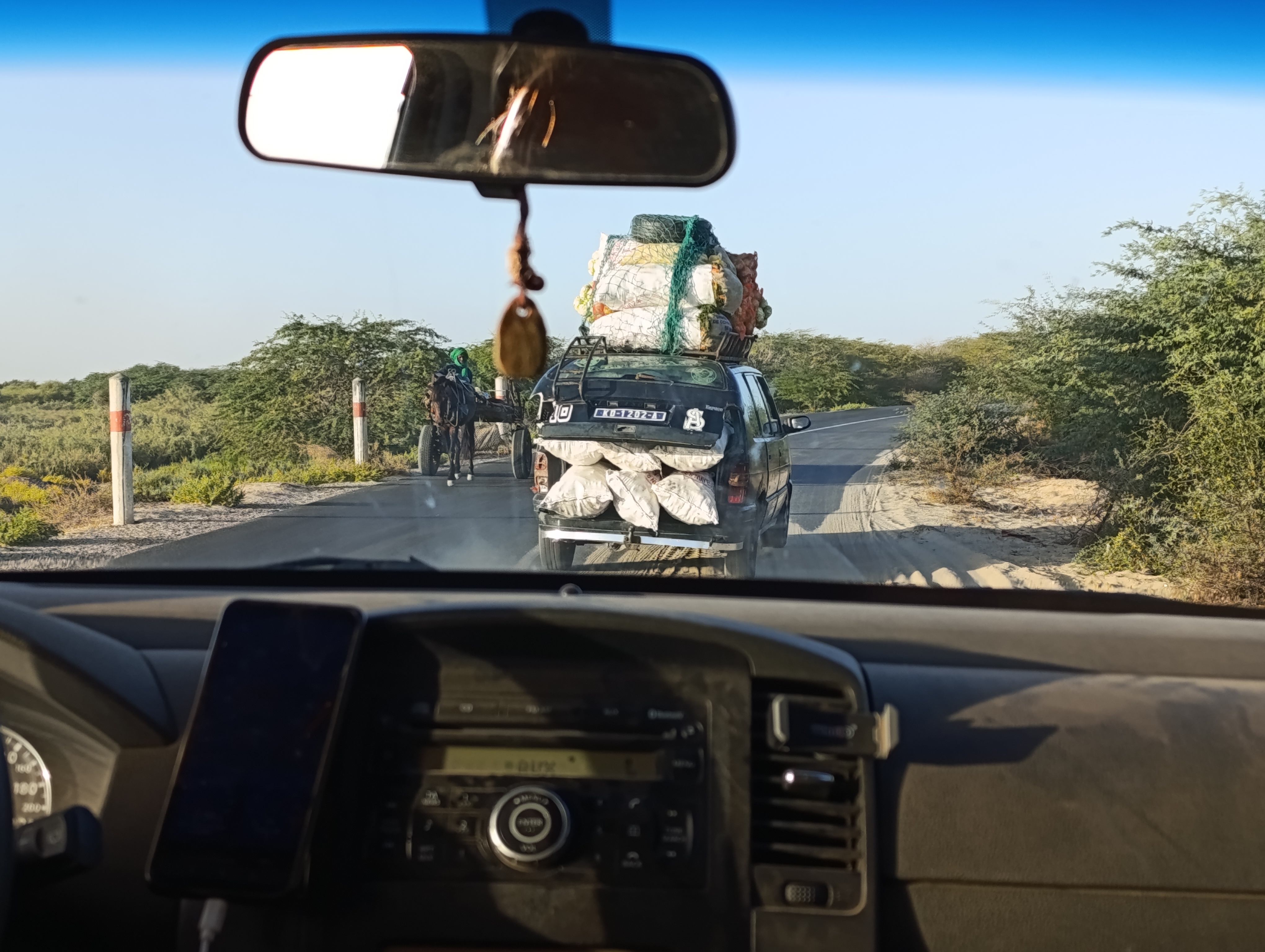 Car with an open trunk, packed with sacks